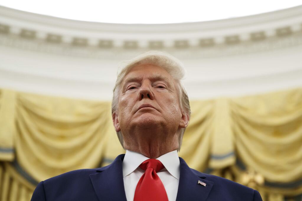 FILE - In this Oct. 24, 2019 file photo, President Donald Trump stands during a Presidential Medal of Freedom ceremony for auto racing great Roger Penske in the Oval Office of the White House in Washington. (AP Photo/Alex Brandon)