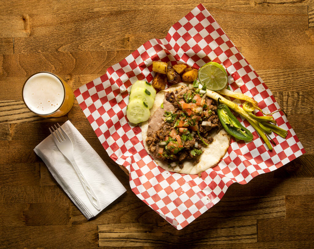Santana taco with carne asada from the Tacos Tijuana food truck with a Dope-alicioous IPA from Shady Oak Barrel House in Santa Rosa on Friday, Oct. 22, 2021. (John Burgess/The Press Democrat)