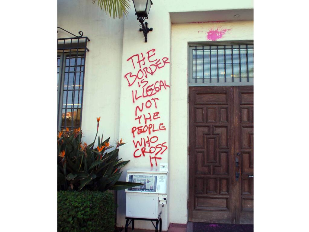Graffiti and paint are splattered on the entrance to the Santa Barbara News-Press building Thursday, Jan. 8, 2015, in Santa Barbara, Calif. (AP Photo/Santa Barbara News-Press, Scott Steepleton)