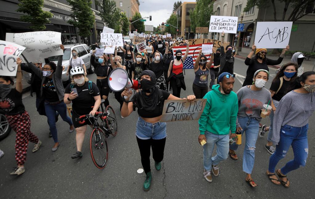 A large group of protesters walk north on Mendocino Avenue in Santa Rosa on Saturday, May 30, 2020, as they protest the death of George Floyd in Minneapolis. (Kent Porter / The Press Democrat) 2020