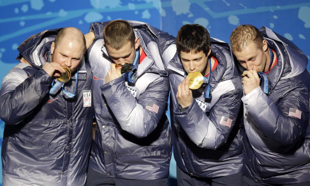 FILE - In this Feb. 27, 2010, file photo, from left, Steven Holcomb, Justin Olsen, Steve Mesler and Curtis Tomasevicz, of the United States, kiss their gold medasl in the men's four-man bobsled during the medal ceremony of the Vancouver 2010 Olympics in Whistler, British Columbia. Holcomb, the longtime U.S. bobsledding star who drove to three Olympic medals after beating a disease that nearly robbed him of his eyesight, was found dead in Lake Placid, N.Y., on Saturday, May 6, 2017. He was 37.(AP Photo/Jin-man Lee, File)