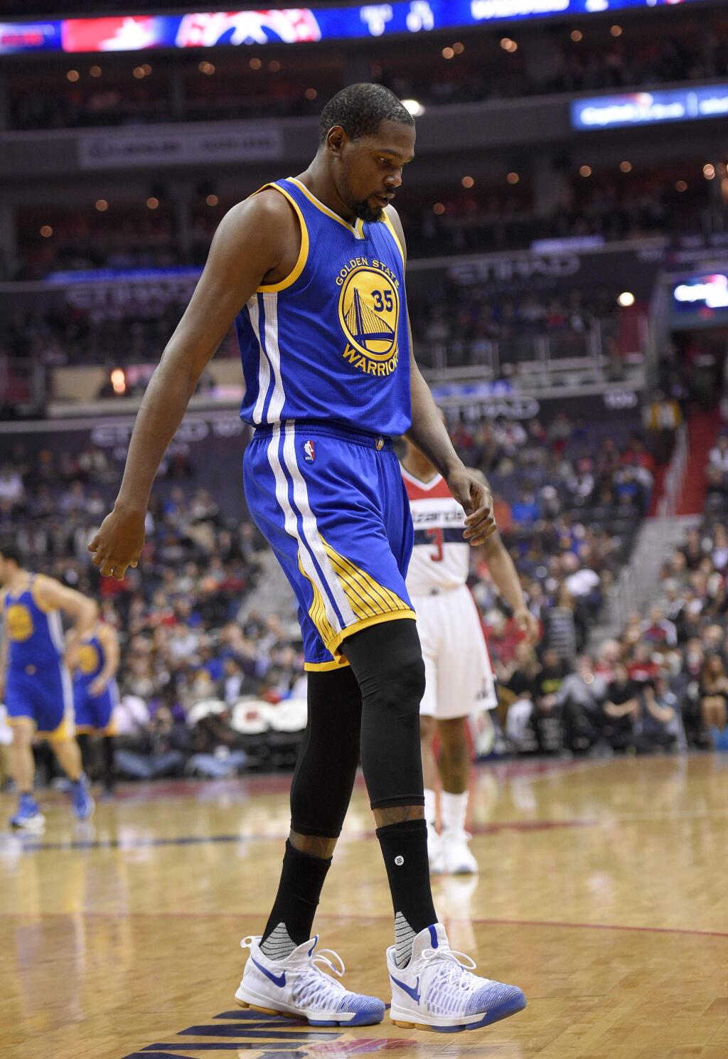 Golden State Warriors forward Kevin Durant (35) walks to the bench during the first half of an NBA basketball game against the Washington Wizards, Tuesday, Feb. 28, 2017, in Washington. Durant hyperextended his left knee and exited the Golden State Warriors' game at the Washington Wizards for good after all of 93 seconds Tuesday night. (AP Photo/Nick Wass)