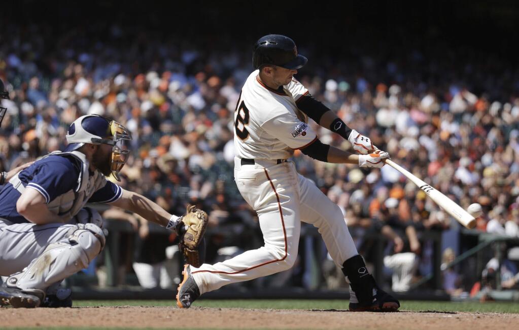 San Francisco Giants' Buster Posey swings for a two-run double off San Diego Padres' Brandon Maurer during the eighth inning of a game Thursday, June 25, 2015, in San Francisco. (AP Photo/Ben Margot)