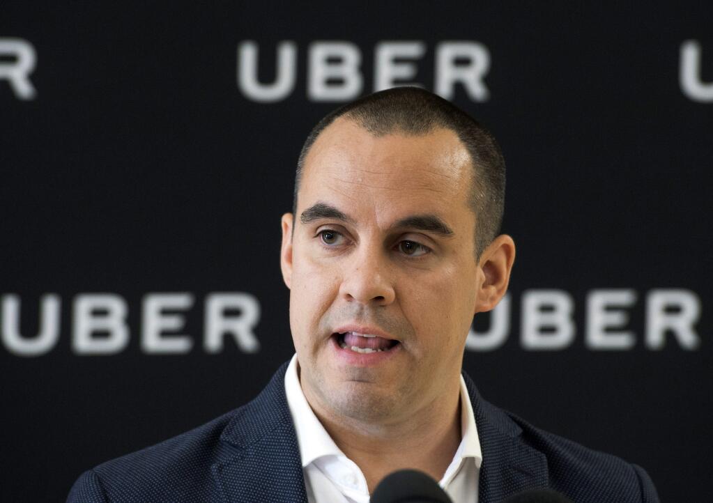 FILE - In this Sept. 26, 2017 file photo, Jean-Nicolas Guillemette, Uber Quebec's general manager, speaks at a news conference in Montreal. Uber is backing down on a threat to shutter its operations in Quebec this weekend. The San Francisco-based company announced Friday, Oct. 13, that it will not pull the plug after all because it hopes to reach a deal with the province's new transport minister in the coming months.(Ryan Remiorz/The Canadian Press via AP)