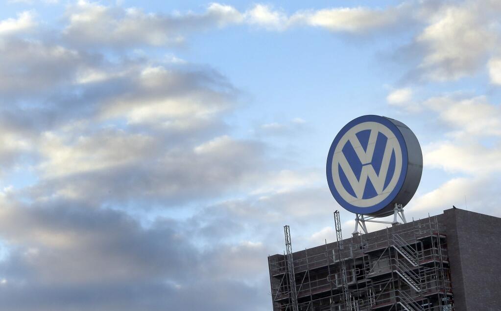 FILE - In this Sept. 26, 2015 file photo a giant logo of the German car manufacturer Volkswagen is pictured on top of a company's factory building in Wolfsburg, Germany. Volkswagen will announce its second-quarter earnings on Thursday, July 27, 2017. (AP Photo/Michael Sohn, file)