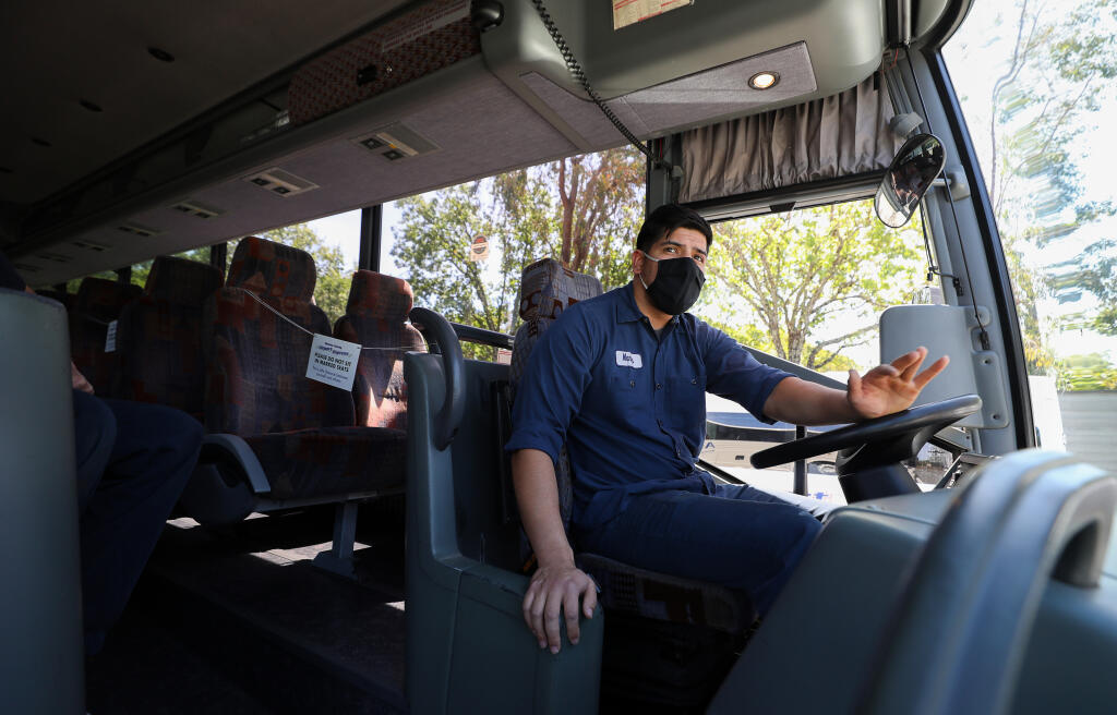 Diesel technician Manny Nunez moves an Airport Express bus into position to be inspected in Santa Rosa on Thursday, April 29, 2021.  (Christopher Chung/ The Press Democrat)
