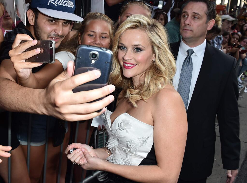 Reese Witherspoon takes a photo with a fan at the premiere of 'Hot Pursuit' at the TCL Chinese Theatre on Thursday, April 30, 2015, in Los Angeles. (Photo by Jordan Strauss/Invision/AP)