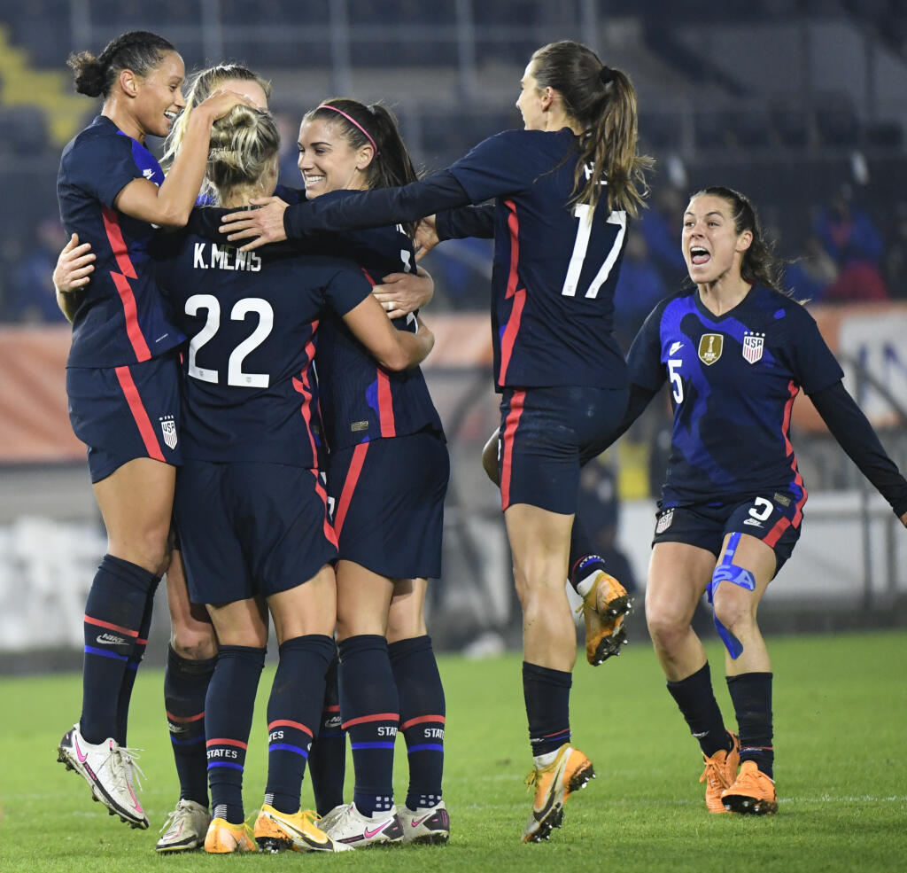 United States players celebrate with Kristie Mewis, number 22, who scored her side's second goal during the international friendly women's soccer match between The Netherlands and the US at the Rat Verlegh stadium in Breda, southern Netherlands, Friday Nov. 27, 2020. (Piroschka van de Wouw/Pool via AP)