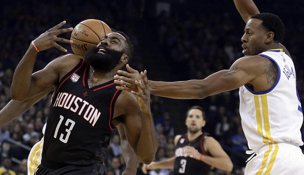 Houston Rockets' James Harden (13) loses the ball to Golden State Warriors' Andre Iguodala, right, during the first half of an NBA basketball game Thursday, Dec. 1, 2016, in Oakland, Calif. (AP Photo/Ben Margot)