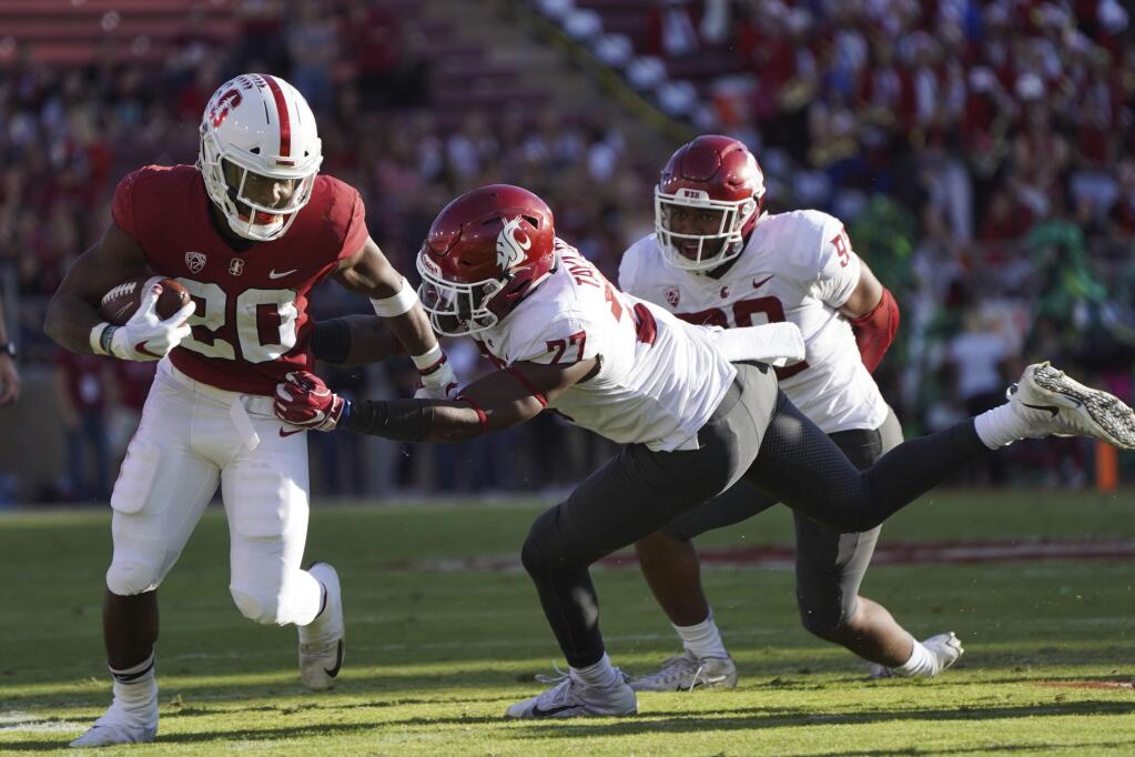 Stanford running back Bryce Love runs downfield in front of Washington St. linebacker Willie Taylor, III, in the first half during an NCAA college football game on Saturday, Oct. 27, 2018, in Stanford, Calif. (AP Photo/Don Feria)