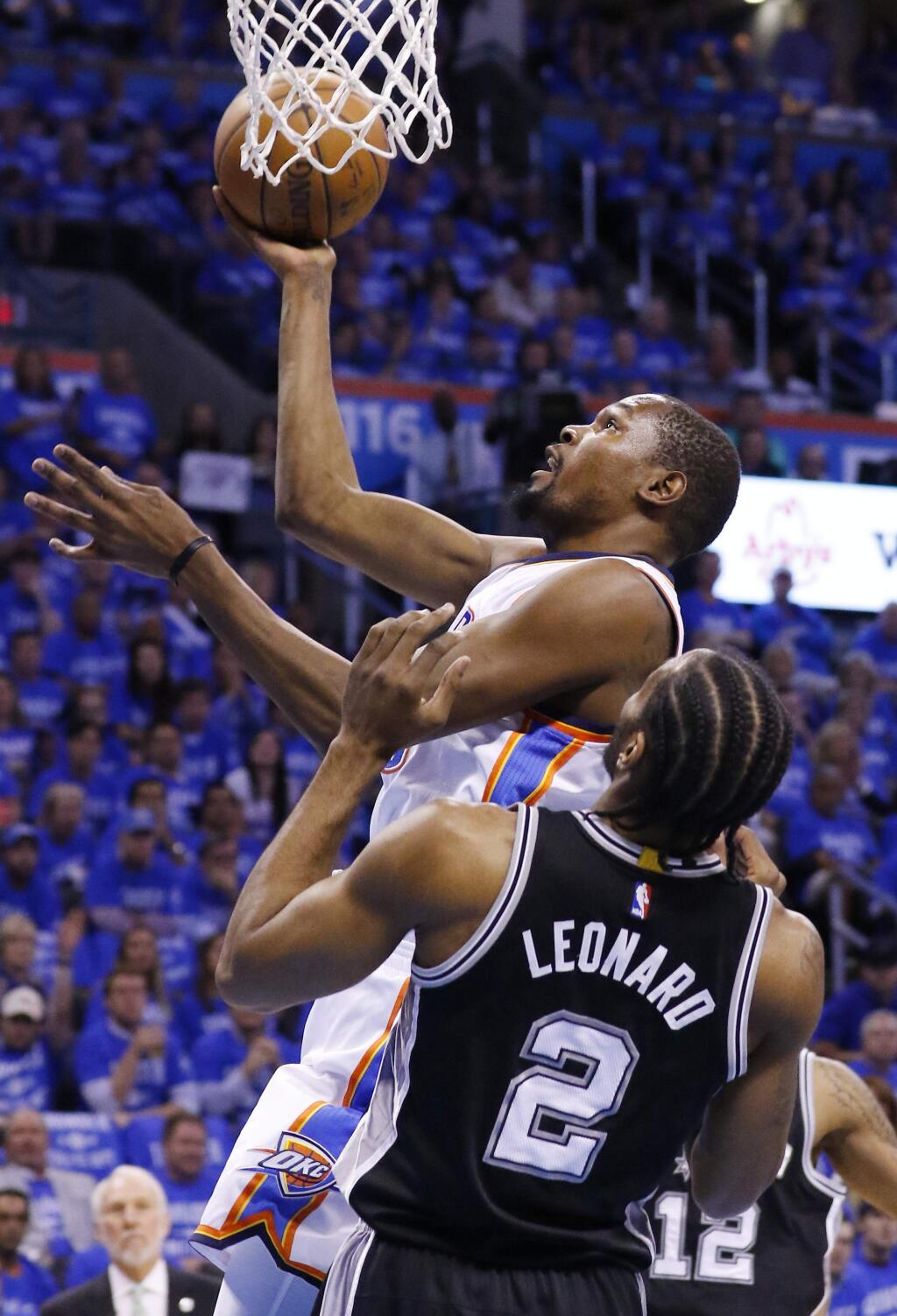 Oklahoma City Thunder forward Kevin Durant, left, shoots in front of San Antonio Spurs forward Kawhi Leonard (2) in the first quarter of Game 6 of a second-round NBA basketball playoff series in Oklahoma City, Thursday, May 12, 2016. (AP Photo/Alonzo Adams)