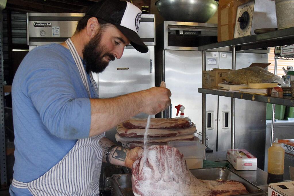 Chad Harris of The Fremont Diner, preparing pork bellies. Harris and his wife Erika are planning to open a restaurant inside Sonoma city limits, at the location of a classic gas station. (Jeff Kan Lee/PD Photos)