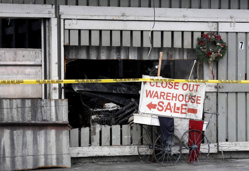 A sign outside the entrance after an early morning fire caused heavy damage to a warehouse at 737 Wilson St. near Railroad Square in Santa Rosa, on Wednesday, December 14, 2016. (BETH SCHLANKER/ The Press Democrat)