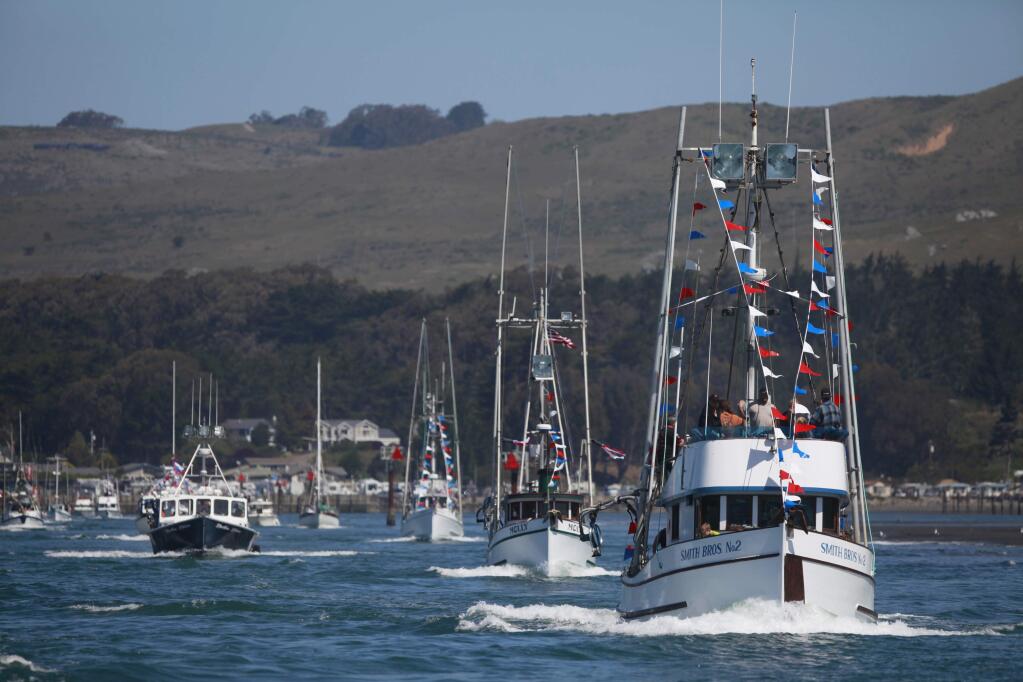 People ride on the Smith Bros. No 2, right, during the Boat Parade as part of the 42nd annual Bodega Bay Fisherman's Festival on Sunday, April 12, 2015 in Bodega Bay, California . (BETH SCHLANKER/ The Press Democrat)