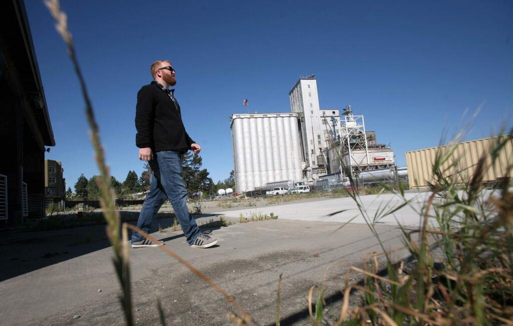 (Charles Hildreth checks out the property where he plans to create a food truck outdoor eatery anchored by a beer bar and garden on Baylis Street off of East Washington St. in Petaluma on Tuesday, April 14, 2015. (SCOTT MANCHESTER/ARGUS-COURIER STAFF)