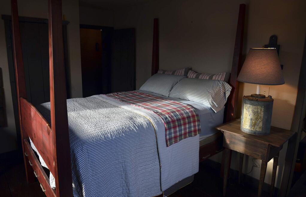 FILE - This Nov. 11, 2013 file photo shows a bedroom in Belle, W.Va. According to U.S. preliminary research published Tuesday, June 4, 2019, dozing off to late-night TV or sleeping with other lights on may mix up your body clock and lead to weight gain and even obesity. (Craig Cunningham/The Daily Mail via AP, File)