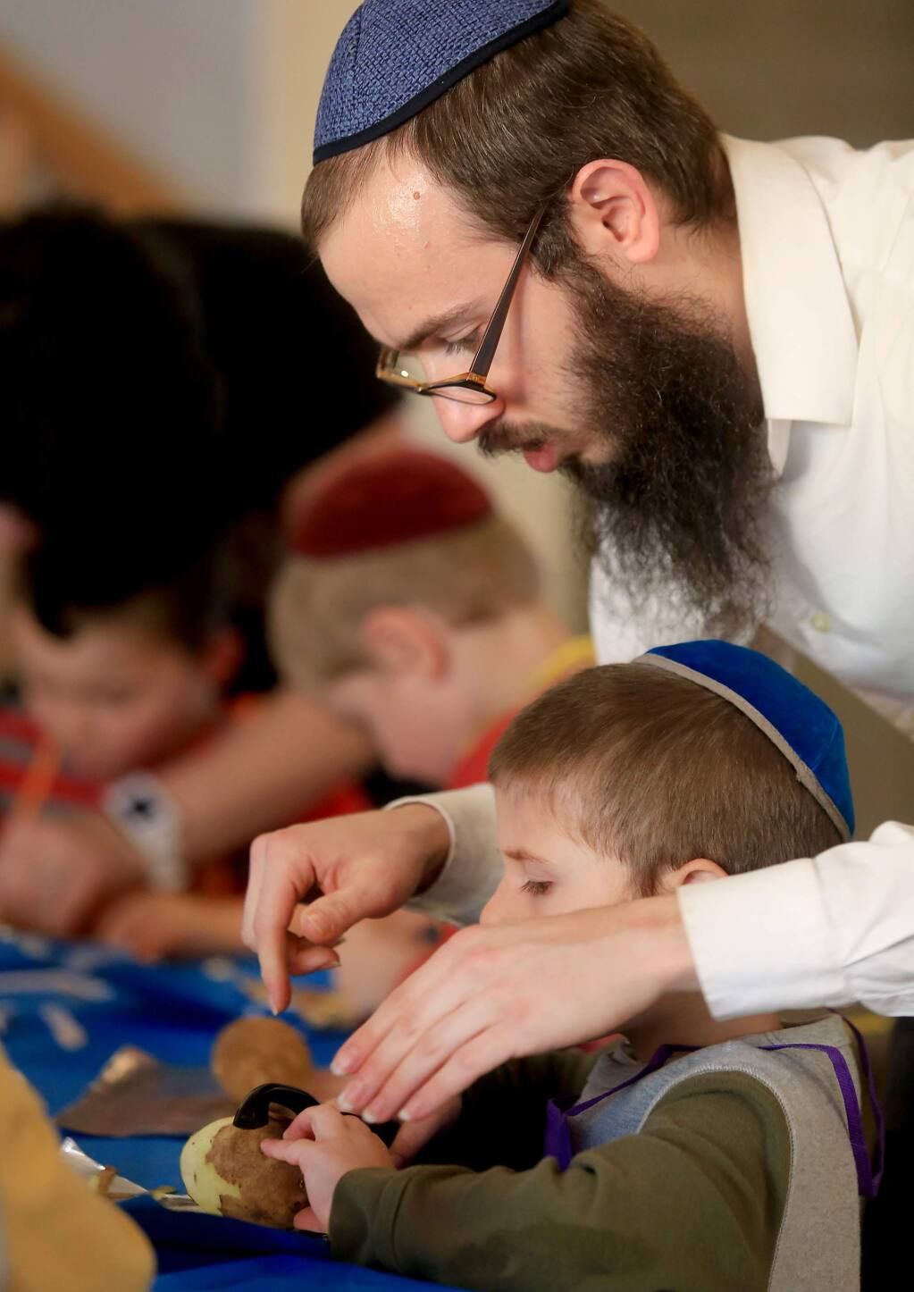 Rabbi Dovid Bush helps his son Shlomie make Boureka, thin Jewish pastries, at their home in Petaluma, as part of the Kids in the Kitchen program run by Dovid's wife, Devorah Bush.Kent Porter Press Democrat