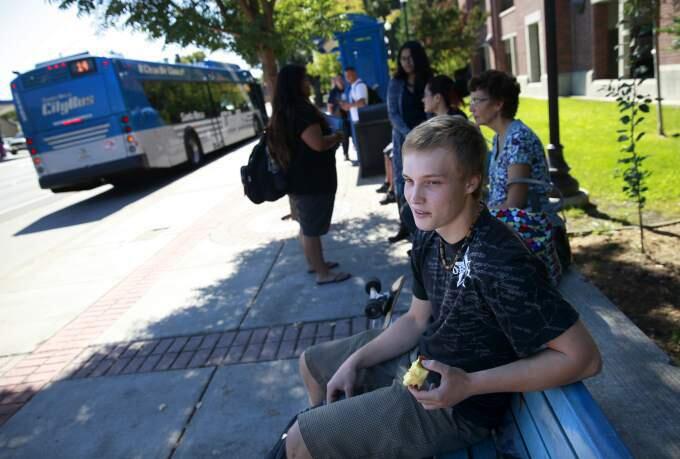 SRJC student Forest Horobin, 17, waits for a bus headed to Forrestville at the bus stop on Mendocino Ave. at Pacific Ave. in Santa Rosa, California on Tuesday, September 30, 2014. (BETH SCHLANKER/ The Press Democrat)