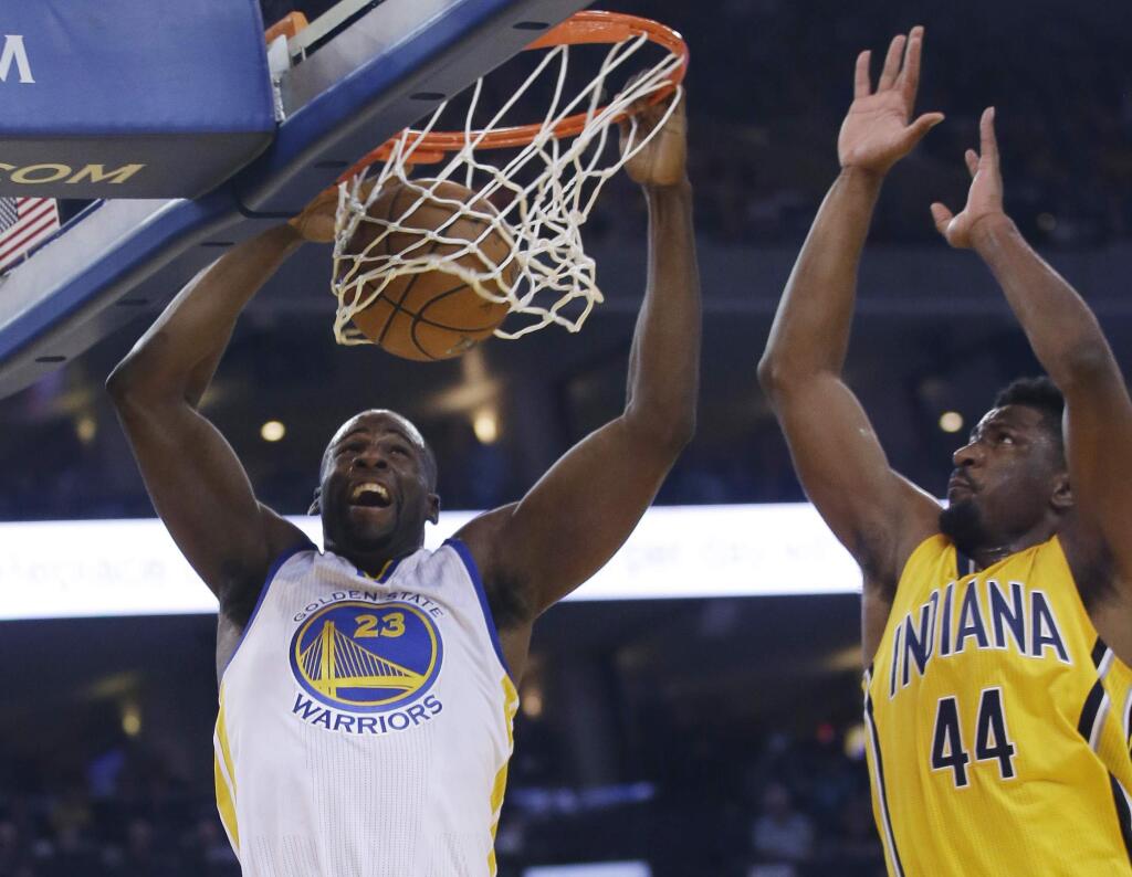 Golden State Warriors' Draymond Green (23) dunks next to Indiana Pacers' Solomon Hill (44) during the first half Friday, Jan. 22, 2016, in Oakland. (AP Photo/Marcio Jose Sanchez)