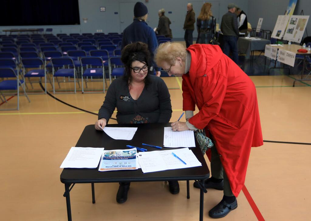 Arielle Kubu-Jones, a field representative for Supervisor Susan Gorin, checks in attendees at a fire reubuilding workshop in Santa Rosa earlier this year. A similar workshop will be held at Oakmont on July 28. (Kent Porter / Press Democrat)
