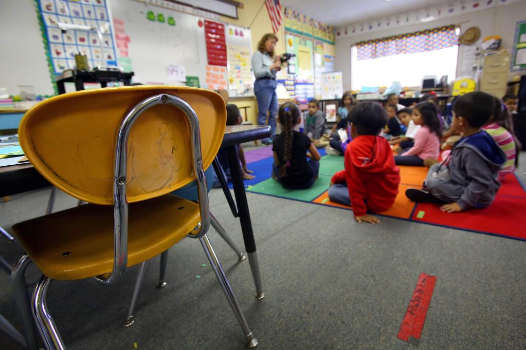 Old plastic chairs that need to be replaced are still in use in Lisa Smith's kindergarten class at James Monroe Elementary School, in Santa Rosa on Friday, August 29, 2014. (Christopher Chung/ The Press Democrat)