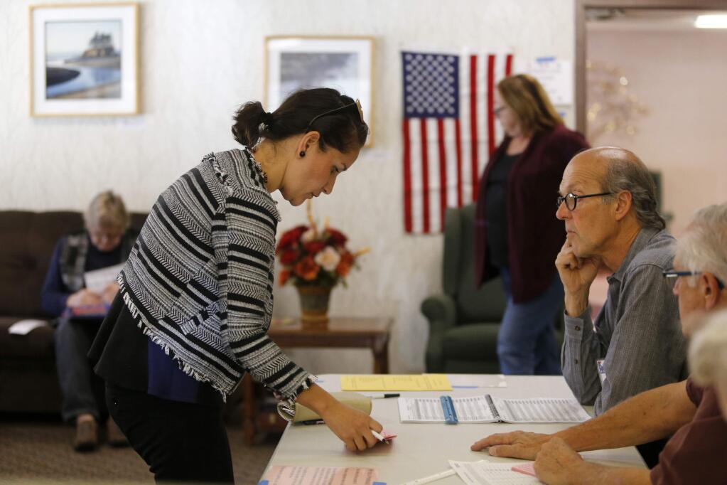 Guadalupe Navarro gets a provisional ballot at Valley Orchards Retirement Community on Tuesday, November 8, 2016 in Petaluma, California . (BETH SCHLANKER/ The Press Democrat)