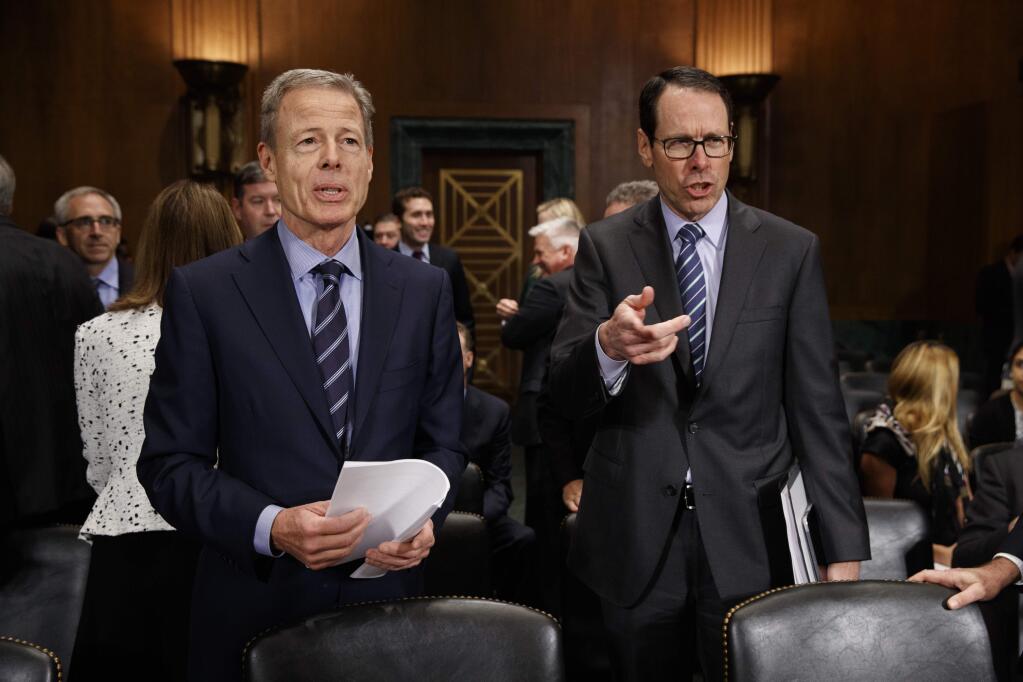 AT&T Chairman and CEO Randall Stephenson, right, and Time Warner Chairman and CEO Jeffrey Bewkes stand on Capitol Hill in Washington, Wednesday, Dec. 7, 2016, prior to testifying before a Senate Judiciary subcommittee hearing on the proposed merger between AT&T and Time Warner. (AP Photo/Evan Vucci)