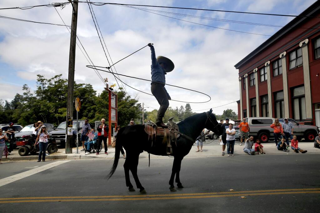 Jonny Gonzalez of Sonoma performs with a lasso on the back of his horse during Penngrove's 39th annual 'Biggest Little Parade' on Sunday, July 5, 2015 in Penngrove, California . (BETH SCHLANKER/ The Press Democrat)