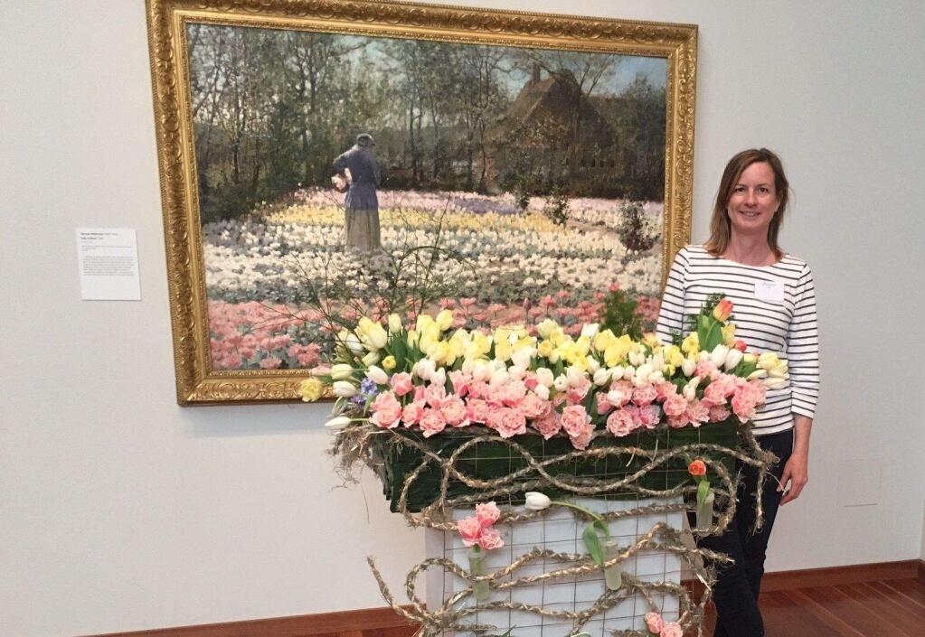 Susan Kelly, of Marion Moss FLoral Design, with her very first desing at the De Young Museum's 'Bouquets to Art' event, in 2016. The painting is 'A Tulip Field.'