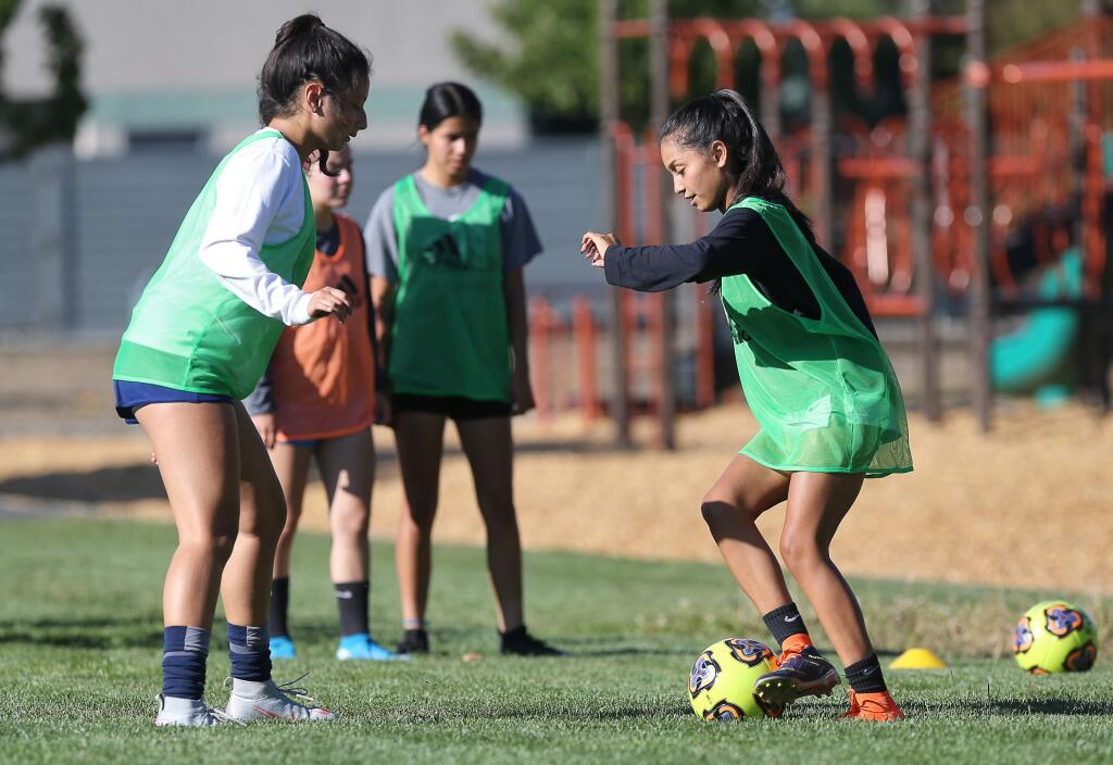 Roseland University Prep soccer players Stephanie Guzman, right, and Kensy Mendoza go through drills during practice in Santa Rosa on Tuesday, Oct. 1, 2019. (Christopher Chung / The Press Democrat)