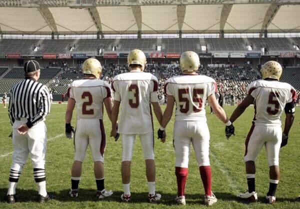 Cardinal Newman captains from left to right Jeff Badger, Randy Wright, Jonathan Steele and Joe Ferguson await the referee's signal to go to the center of the field for the coin toss during the CIF State Football Division II Championship held at the Home Depot Center in Carson, Ca., Saturday, Dec. 20, 2008. Newman lost 28-6.
