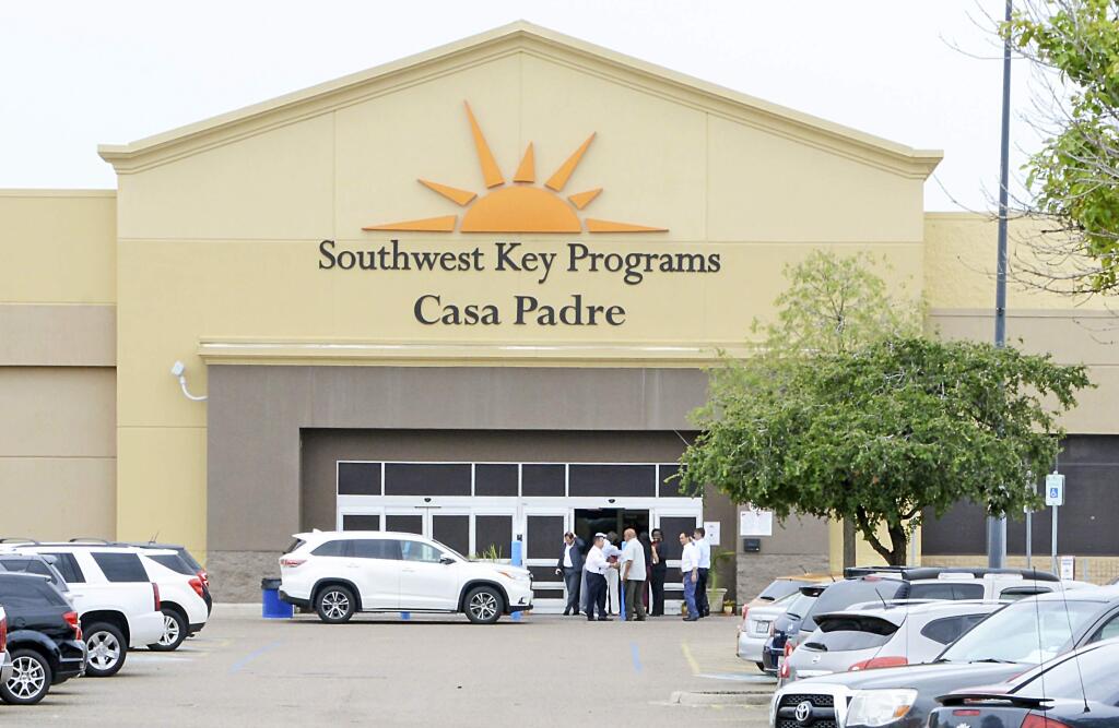 FILE - In this June 18, 2018 file photo, dignitaries take a tour of Southwest Key Programs Casa Padre, a U.S. immigration facility in Brownsville, Texas, where children who have been separated from their families are detained. (Miguel Roberts /The Brownsville Herald via AP, File)