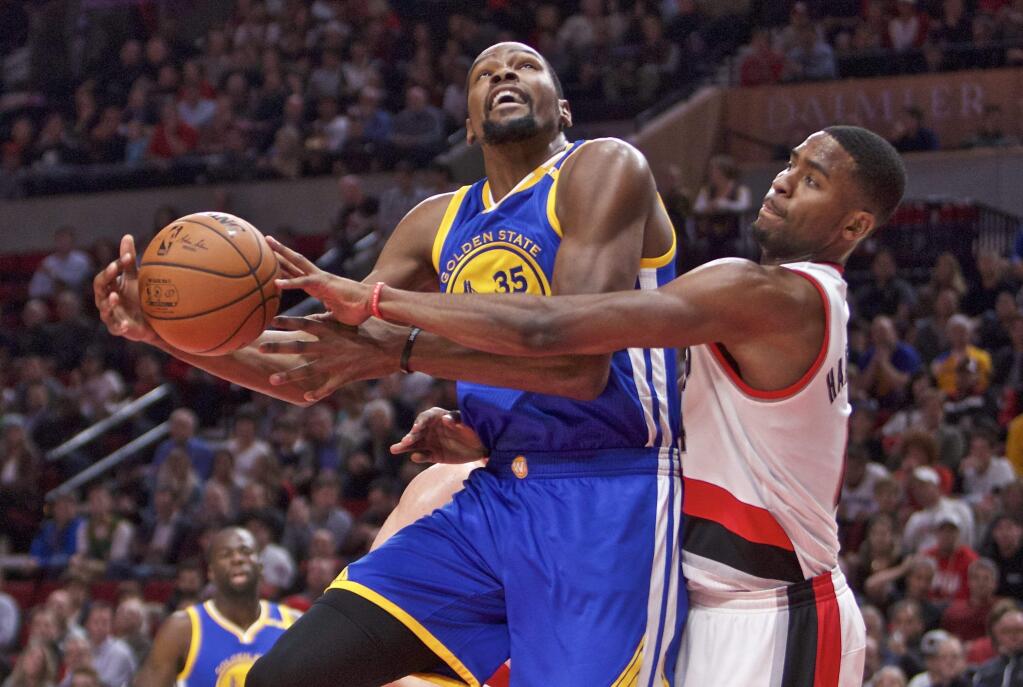 Golden State Warriors forward Kevin Durant, left, is fouled by Portland Trail Blazers forward Maurice Harkless, right, during the first half of a game in Portland, Ore., Tuesday, Nov. 1, 2016. (AP Photo/Craig Mitchelldyer)