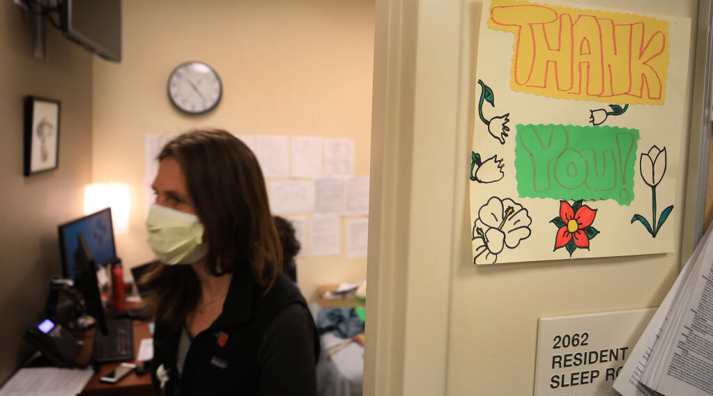 Veronica Jordan an ICU doctor at Sutter Santa Rosa Regional Hospital, Thursday, March 11, 2021. Signs of encouragement are on display in the 'hive' used by residents to gather they thoughts, exchange information and complete patient paperwork.  (Kent Porter / The Press Democrat) 202
