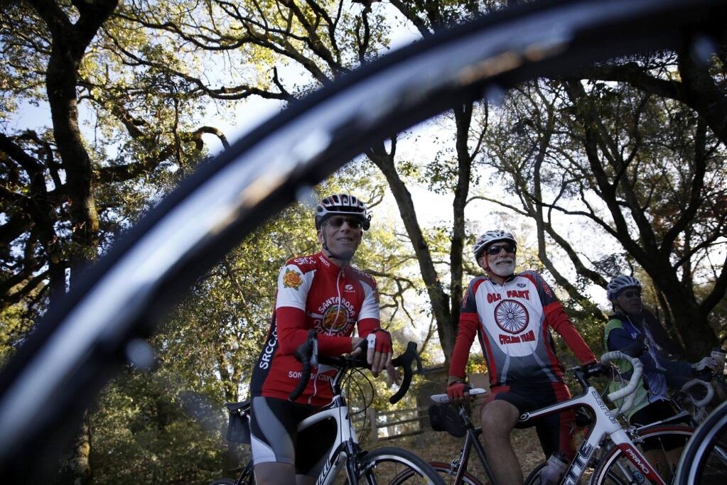 Cyclists Bob Owen, left, and Frankie Sottile meet up with members of the Santa Rosa Cycling Club at Howarth Park before the start of their ride in Santa Rosa on Wednesday, Oct. 2, 2013. (BETH SCHLANKER / The Press Democrat)