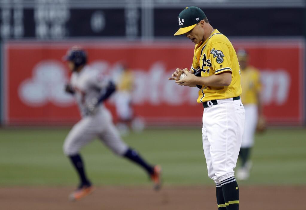 Oakland Athletics pitcher Sonny Gray, right, waits for the Houston Astros' George Springer to run the bases after Springer hit a home run during the first inning Tuesday, June 20, 2017, in Oakland. (AP Photo/Ben Margot)