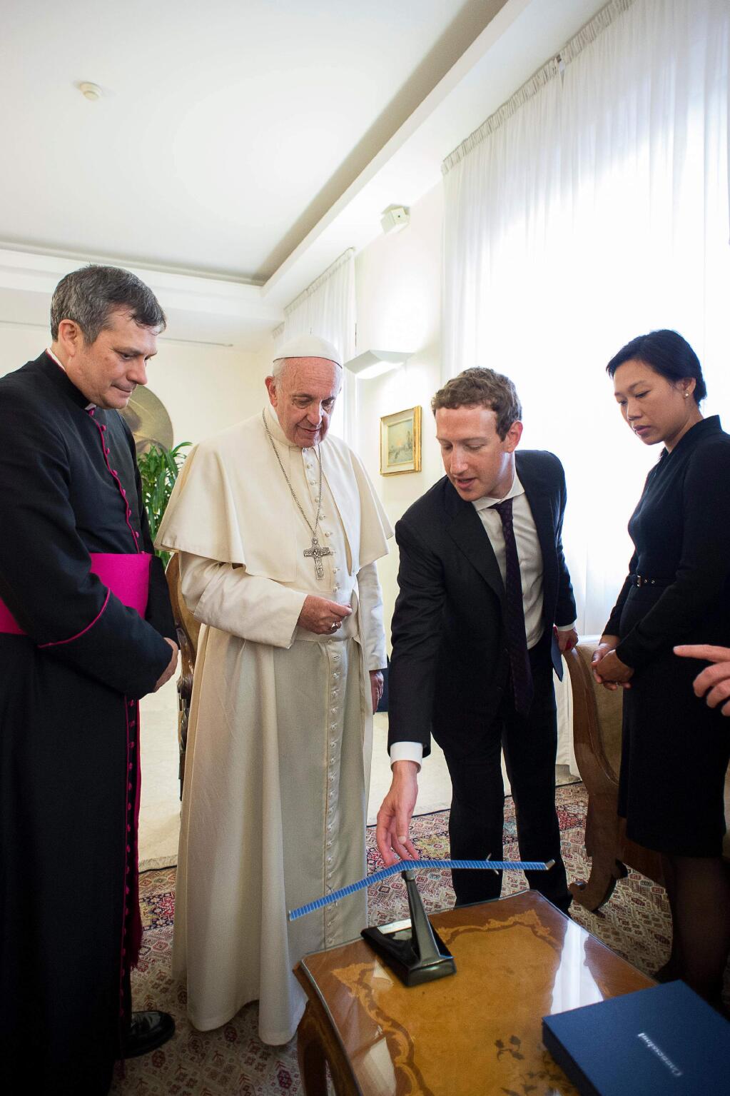 Pope Francis meets Facebook founder and CEO Mark Zuckerberg, second from right, and his wife Priscilla Chan, right, at the Santa Marta residence, the guest house in Vatican City where the pope lives, Monday, Aug. 29, 2016. Vatican spokesman Greg Burke says a topic of discussion at Monday's meeting was “how to use communication technologies to alleviate poverty, encourage a culture of encounter, and make a message of hope arrive, especially to those most in need.'' (L'Osservatore Romano/Pool Photo via AP)