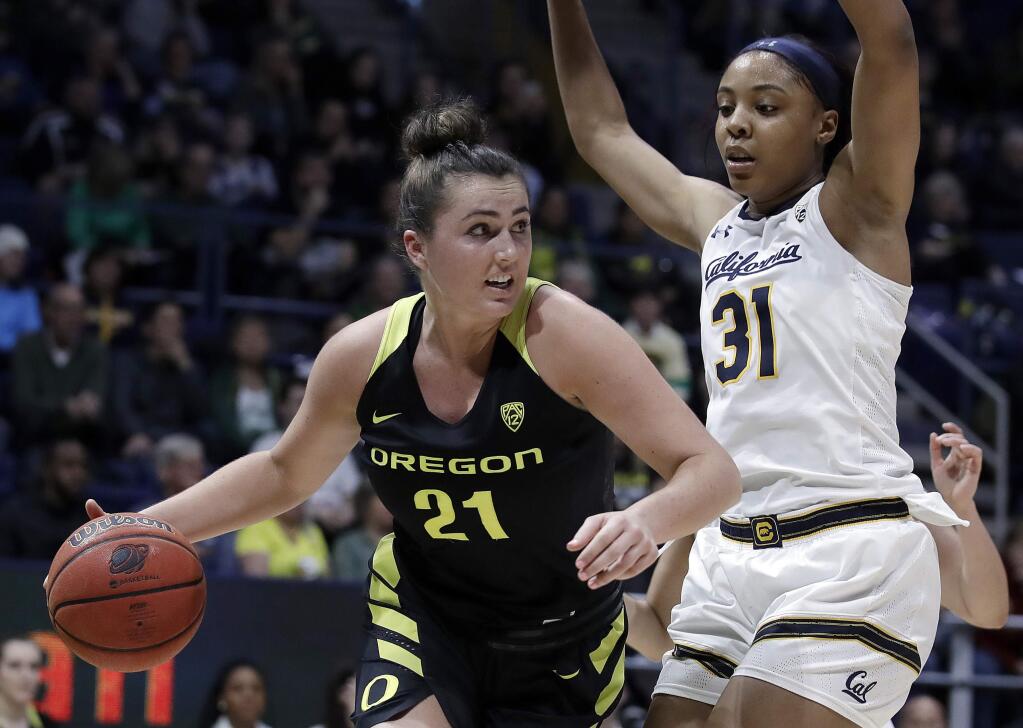 Oregon's Erin Boley, left, drives the ball as Cal's Kristine Anigwe defends during the second half, Friday, Feb. 8, 2019, in Berkeley. (AP Photo/Ben Margot)