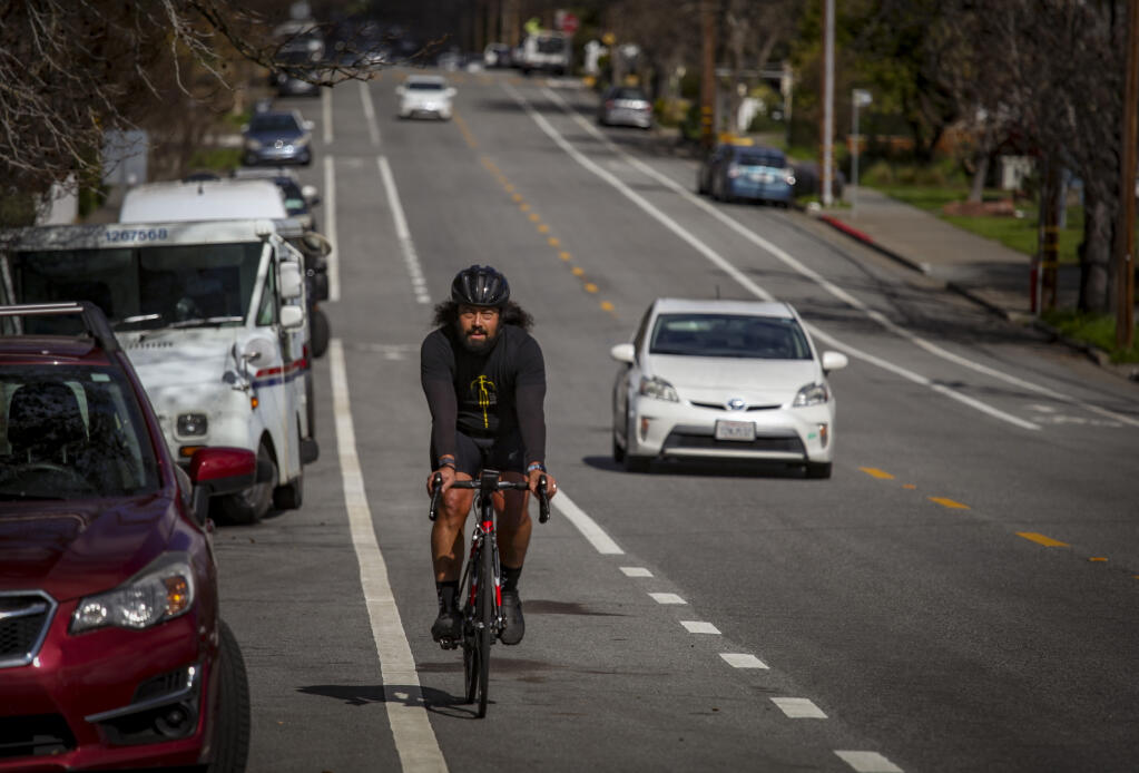 A cyclist uses the bike lane on B Street in west Petaluma. Photographed on Monday, February 26, 2024. (CRISSY PASCUAL/ARGUS-COURIER STAFF)