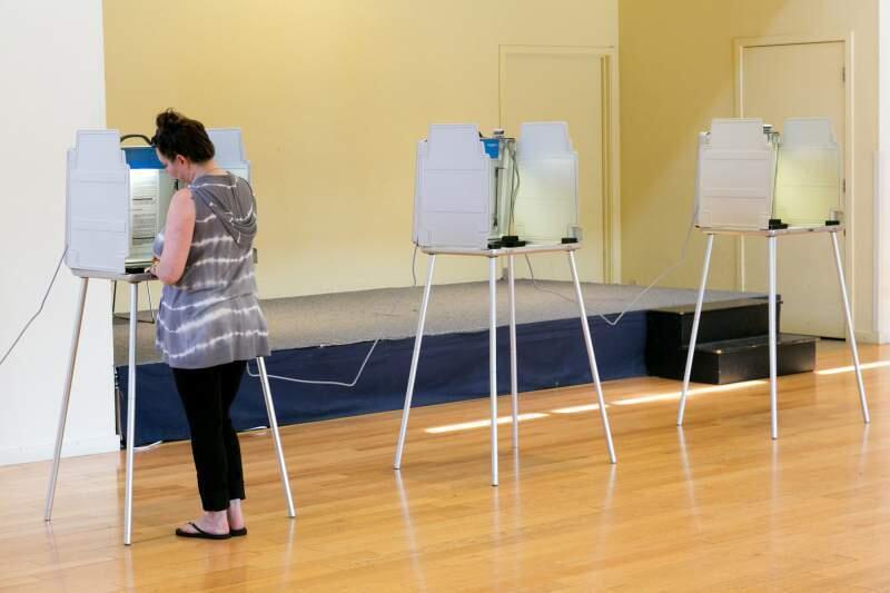 A voter at the Finnish American Home Association casts her ballot last June in the California primary. By then candidates Clinton and Trump had already secured their parties' respective victories.