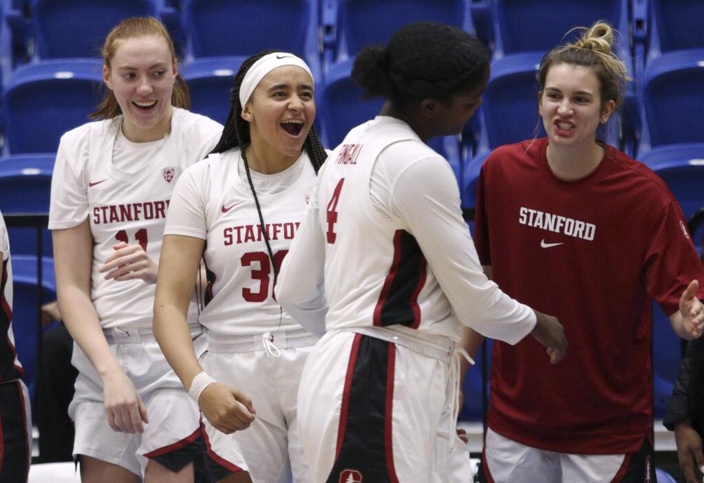 Stanford players celebrate a basket by Nadia Fingall (4) during the second half against California Baptist in Victoria, British Columbia, Thursday, Nov. 28, 2019. (Chad Hipolito/The Canadian Press via AP)