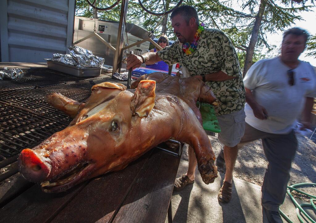 Robbi Pengelly/Index-TribuneRoger Declercq, of Sonoma Gourmet, prepared a roasted pig for the luau.