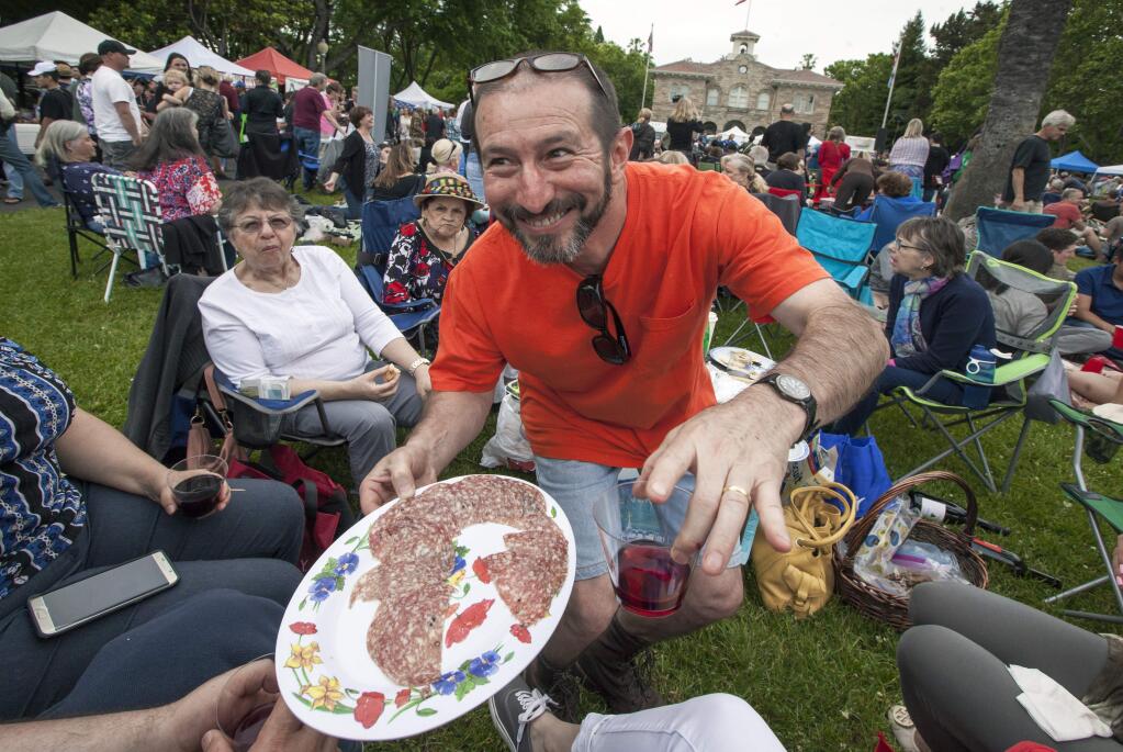 Norberto Ferero Franco offeres antipasto and wine to friends and family at Sonoma Plaza's first Tuesday Farmers Market of 2016. The party atmosphere of the farmers market has caused some to ask for a re-evaluation of the event's purpose and objectives.(Photos by Robbi Pengelly/Index-Tribune)