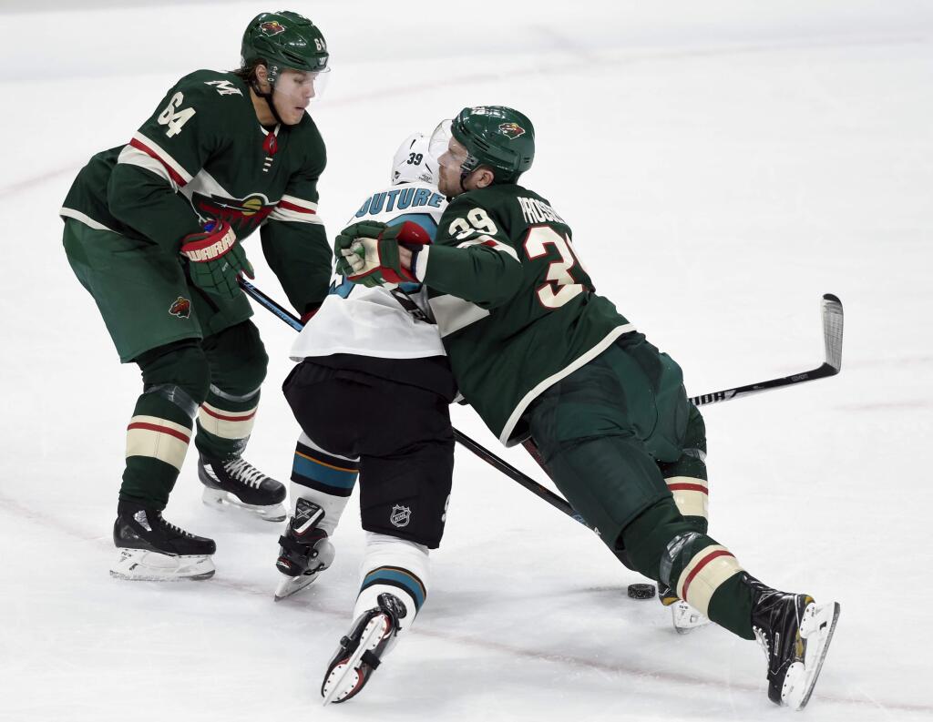 Minnesota Wild's Mikael Granlund (64), of Finland, and Nate Prosser (39) collide with San Jose Sharks' Logan Couture (39) during the first period of an NHL hockey game Sunday, Feb. 25, 2018, in St. Paul, Minn. (AP Photo/Hannah Foslien)