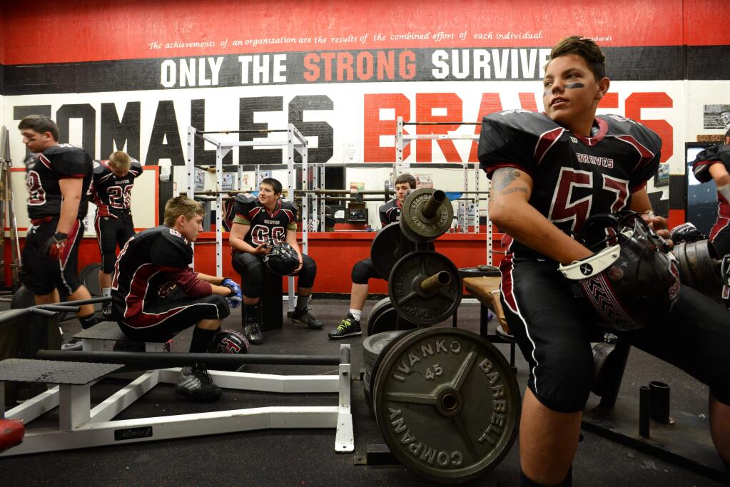 Brandon Hitchcock, right, along with fellow players on the Tomales High School football team, in the weight room before the start of their first game of the season playing 8-man football Saturday, September 5, 2015. (Photo: Erik Castro/for The Press Democrat)