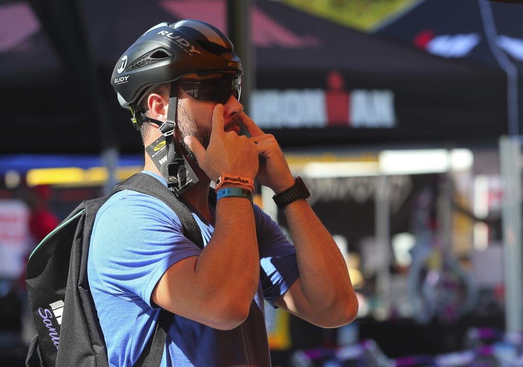 Kyle Finley, from Loomis, tries on a helmet at the Rudy Project booth in Santa Rosa's Old Courthouse Square on Wednesday, May 9, 2018. (Christopher Chung/ The Press Democrat)