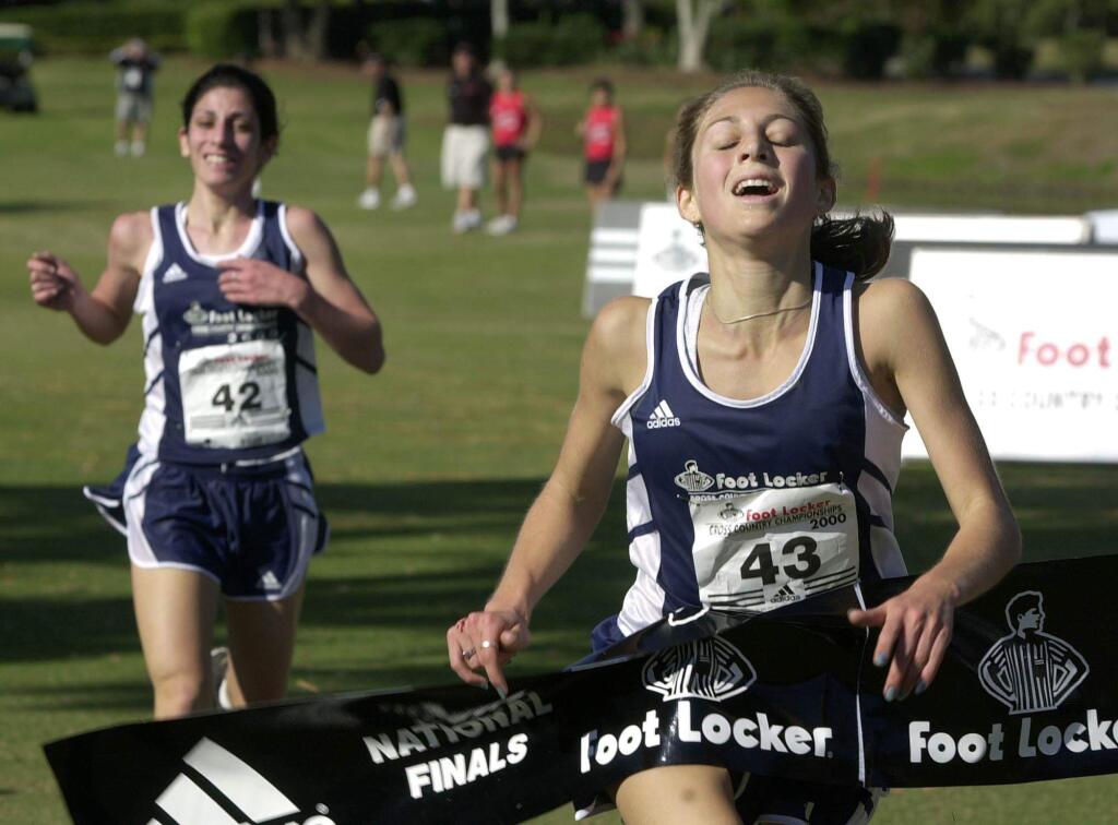 Montgomery High School senior Sara Bei crosses the finish line just ahead of Anita Siraki of Glendale to win the Foot Locker Cross Country Championship on Saturday, Dec.9, 2000 at Disney World's Oak Trails Golf Course in Lake Buena Vista, Fla. Bei ran a course-record time of 16 minutes, 55 seconds. (PRESS DEMOCRAT FILE PHOTO)