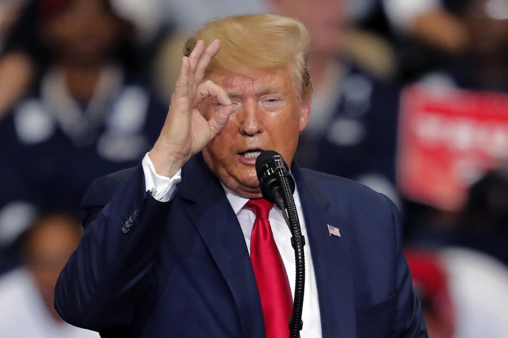 FILE - In this Wednesday Nov. 6, 2019, file photo, President Donald Trump gestures as he speaks at a campaign rally in Monroe, La. A judge in New York on Thursday, Nov. 7, 2019, has ordered President Trump to pay $2 million to settle a lawsuit alleging he misused his charitable foundation to further his political and business interests. Judge Saliann Scarpulla also signed off on an agreement to close the Trump Foundation and distribute about $1.7 million in remaining funds to other nonprofit groups. (AP Photo/Gerald Herbert, File)