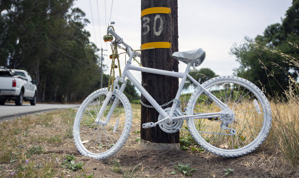 A bicycle painted white, chained to a power pole on Highway 12, where cyclist Adrian Albert was the fatal victim of a hit and run. (Photo by Robbi Pengelly/Index-Tribune)