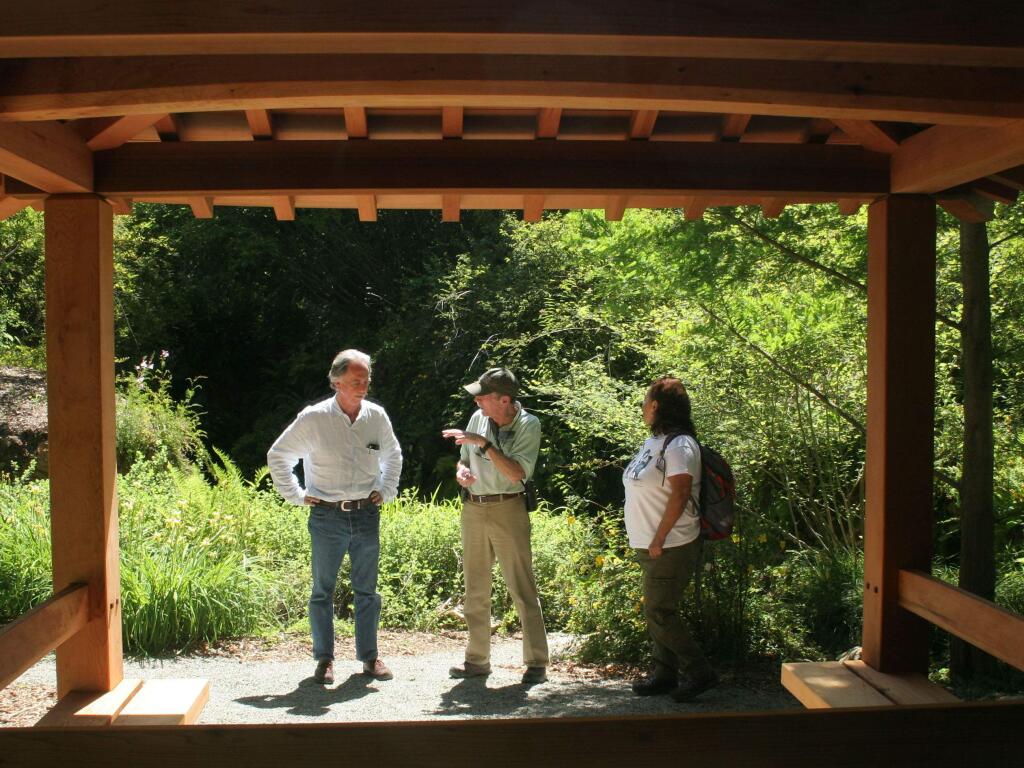 Director William McNamara, left, talks with Quarryhill volunteers at a Japanese 'ting' in the botanical garden. (Christian Kallen/Index-Tribune)